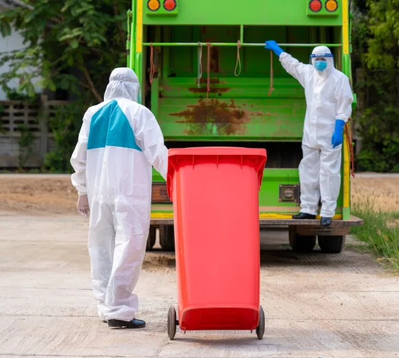 two-garbage-men-hazmat-ppe-protective-clothing-wear-medical-rubber-gloves-working-together-emptying-